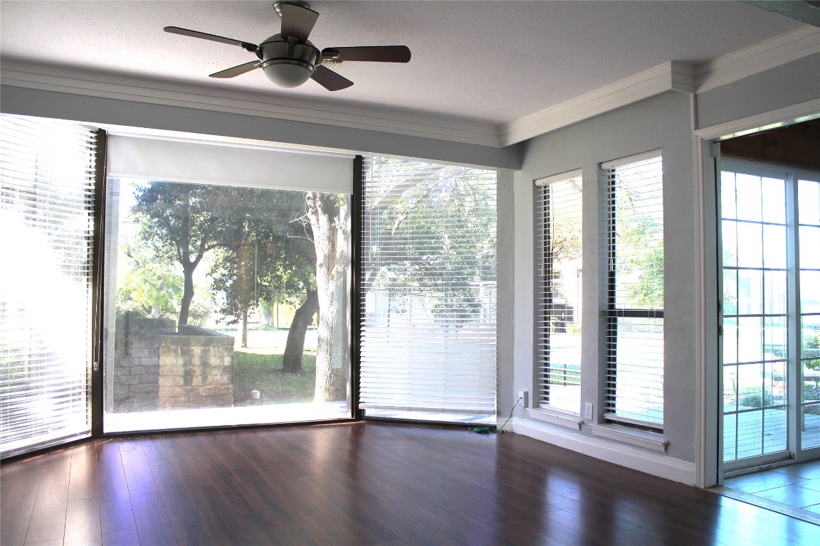 108 World Of Tennis Square, Unit 108C Lakeway, TX 78738 - Photo 19 of 25 a view of an empty room with wooden floor and a window