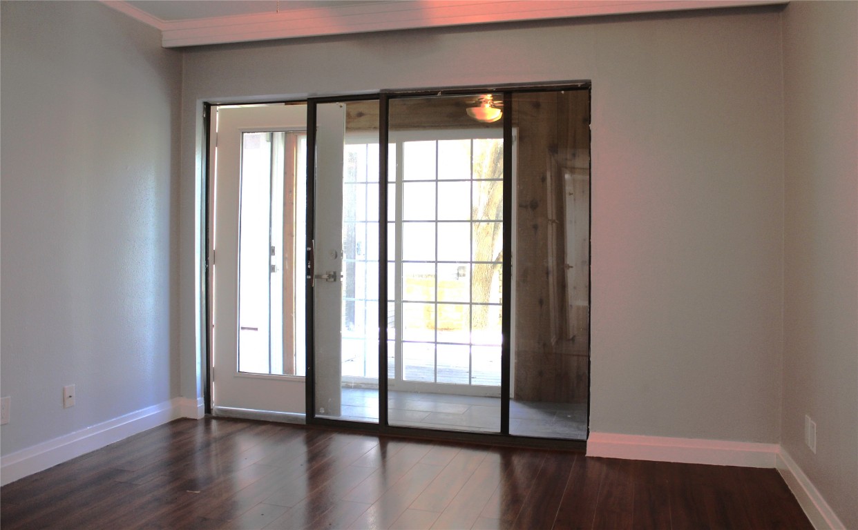 108 World Of Tennis Square, Unit 108C Lakeway, TX 78738 - Photo 24 of 25 wooden floor in an empty room with a window