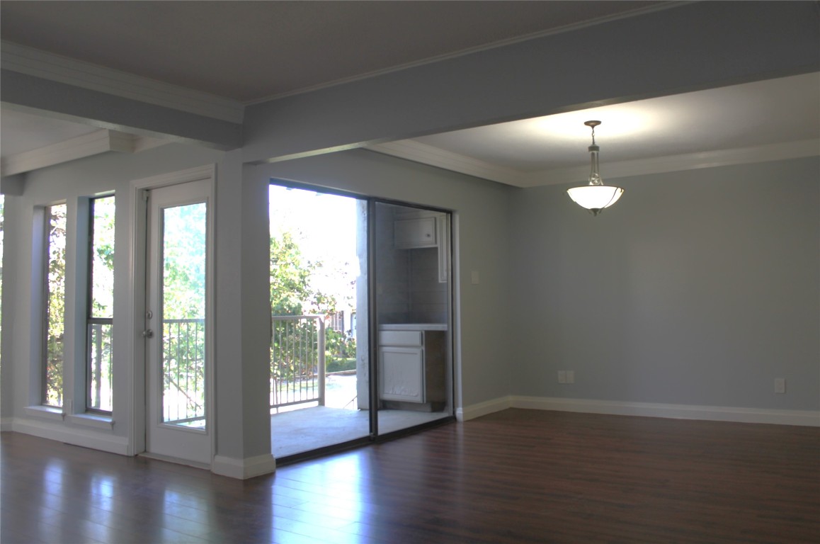108 World Of Tennis Square, Unit 108C Lakeway, TX 78738 - Photo 8 of 25 a view of an empty room with wooden floor and a window