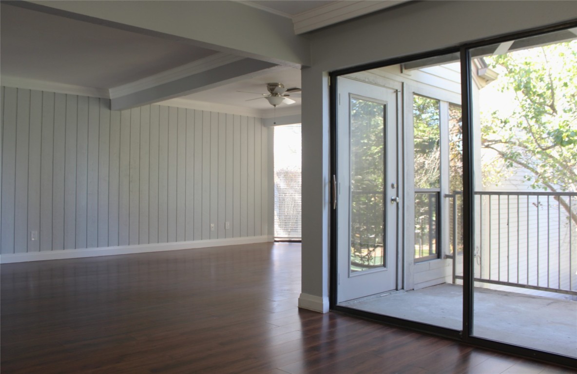 108 World Of Tennis Square, Unit 108C Lakeway, TX 78738 - Photo 9 of 25 a view of an empty room with wooden floor and a window