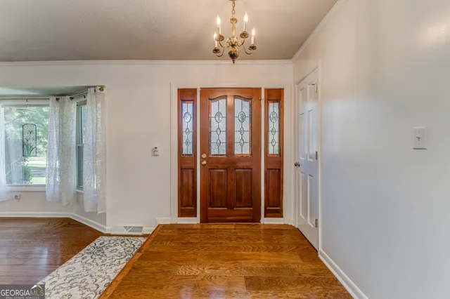 a kitchen with stainless steel appliances granite countertop a sink and dishwasher a stove top oven with wooden floor