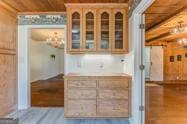 a spacious bedroom with a bed and a flat screen tv