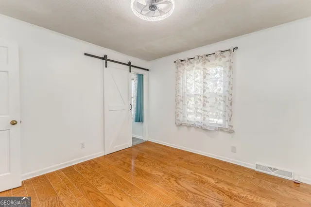 a view of room with large windows and couch