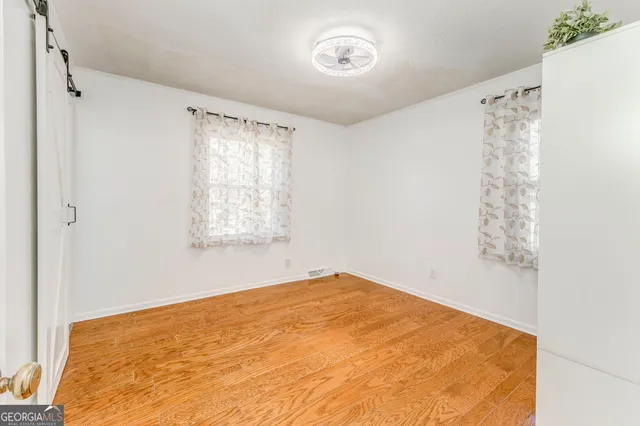 a view of a patio with dining table and chairs and potted plants