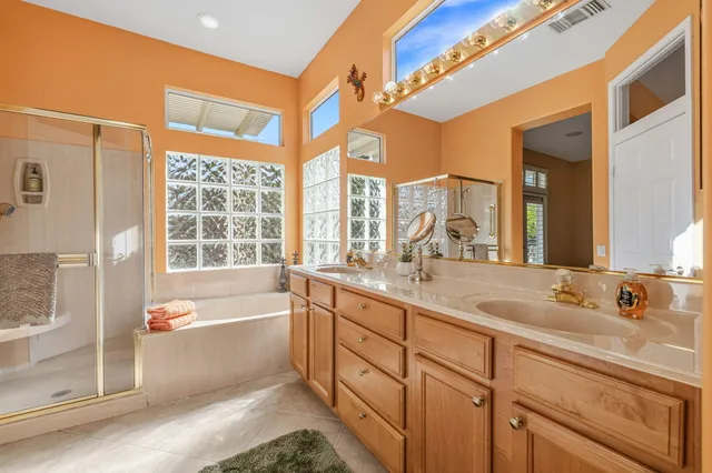 a bathroom with a tub sink and mirror