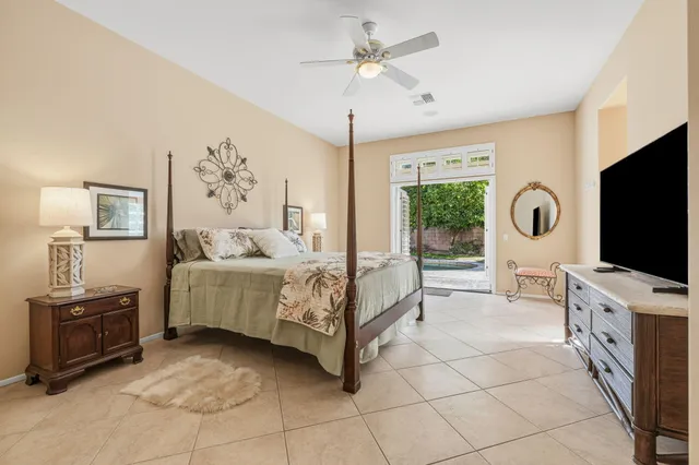 a bedroom with furniture and a flat screen tv