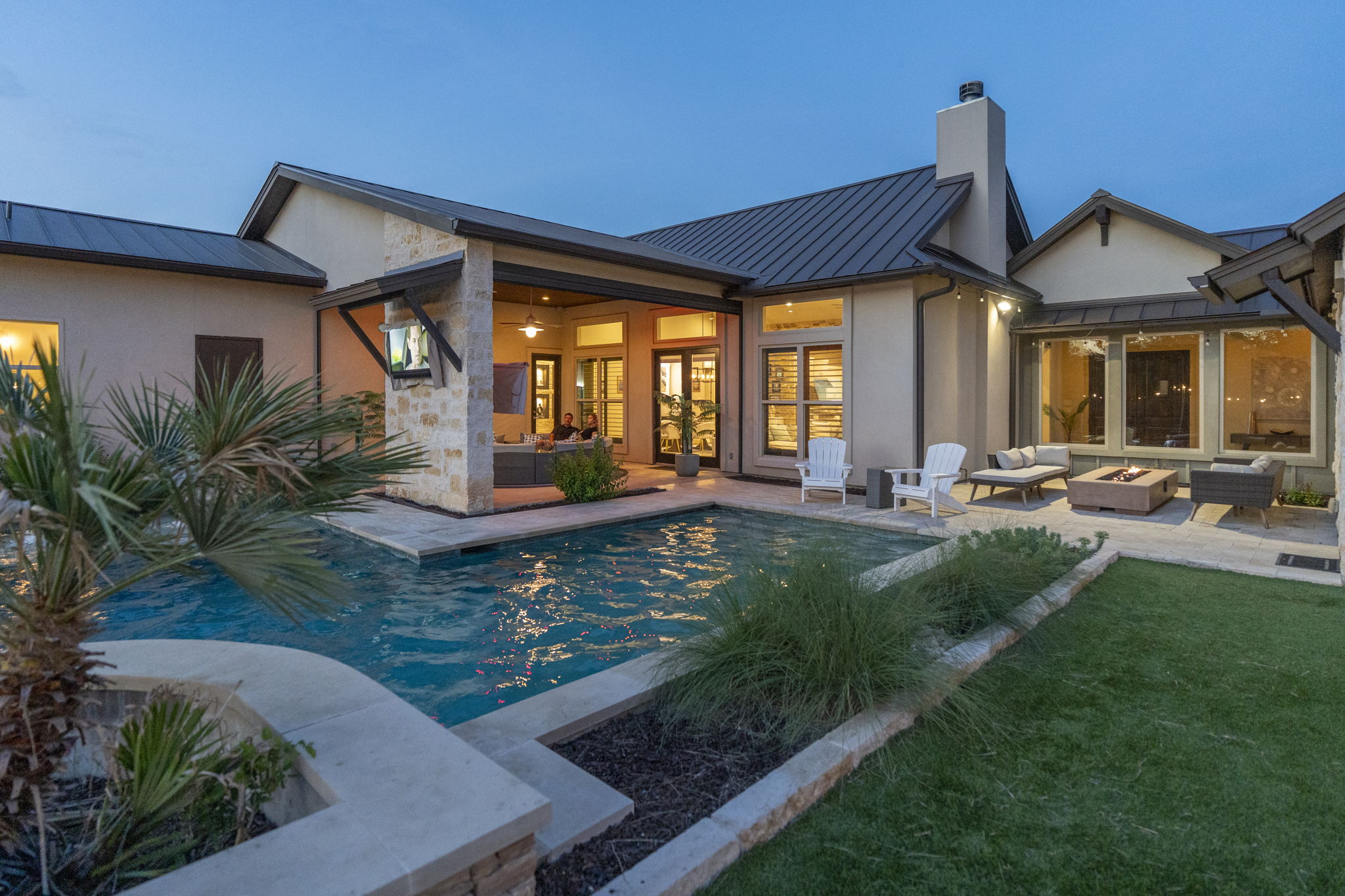 16202 Remuda Trail Buda, TX 78610 - Photo 28 of 40 The property features a private swimming pool with stone coping and lush landscaping, alongside a patio area with a fire pit