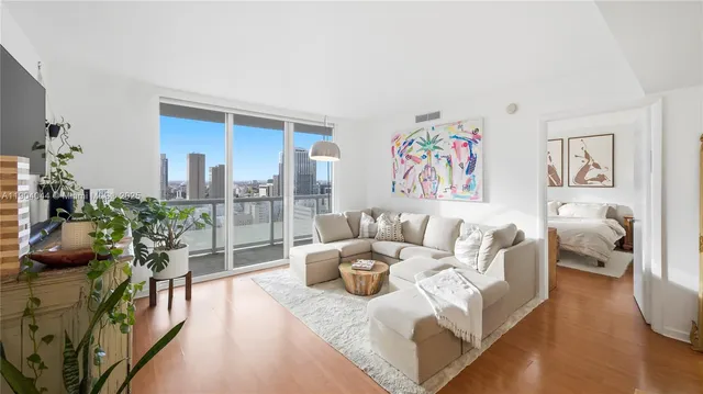 a living room with furniture and a painting on the wall