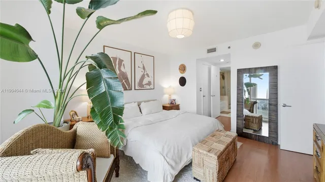 a bedroom with a bed couch and a window