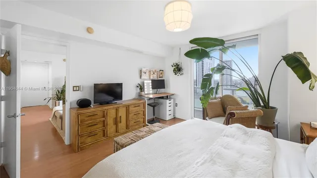 a bedroom with furniture and a flat screen tv
