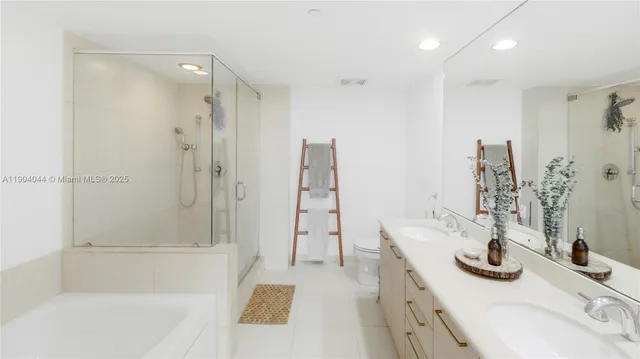 a bathroom with a tub sink and a mirror