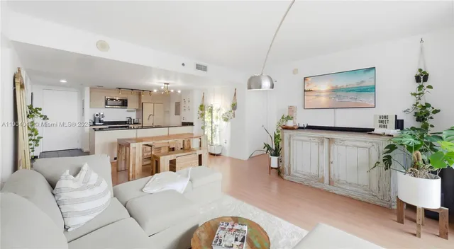 a living room with furniture and a potted plant
