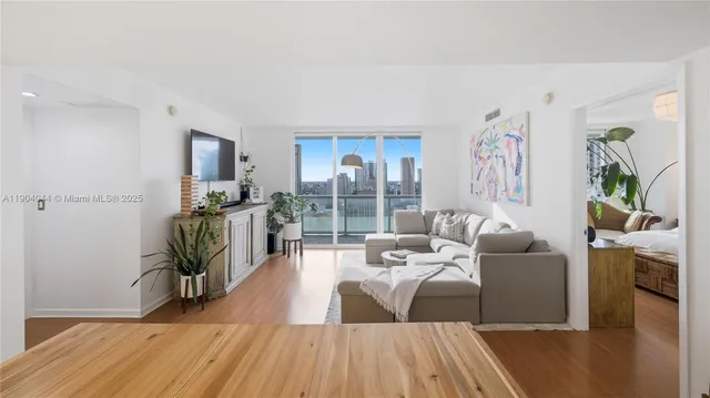 a living room with furniture and a wooden floor