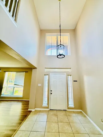 a large kitchen with stainless steel appliances kitchen island granite countertop a large counter top space a stove a sink and a refrigerator