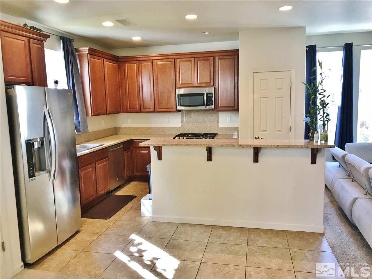 260 Brenham Avenue Reno, NV 89509 - Photo 18 of 20 a kitchen with stainless steel appliances granite countertop a refrigerator sink and cabinets