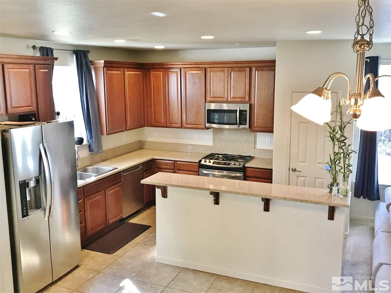 260 Brenham Avenue Reno, NV 89509 - Photo 4 of 20 a kitchen with stainless steel appliances granite countertop a stove a sink and a refrigerator