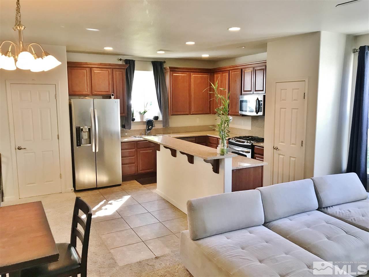 260 Brenham Avenue Reno, NV 89509 - Photo 5 of 20 a kitchen with stainless steel appliances granite countertop a refrigerator a sink a stove and a refrigerator