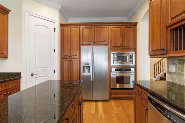 a view of a balcony with chairs and wooden floor