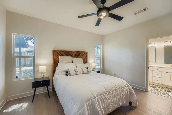 a large kitchen with stainless steel appliances a stove center island wooden floor and cabinets