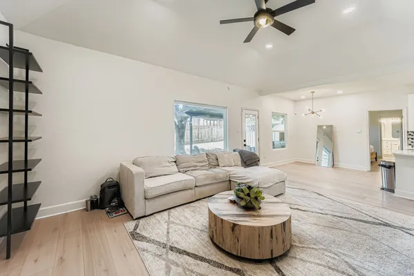 a living room with furniture and a potted plant