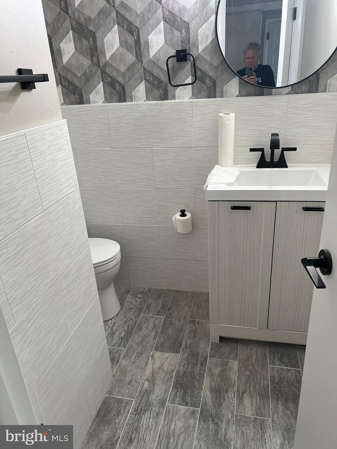 700 Ardmore Ave Ardmore Avenue, Unit 606 Ardmore, PA 19003 - Photo 11 of 32 a bathroom with a sink a toilet and a mirror