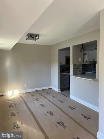 a living room with a couch and floor to ceiling window