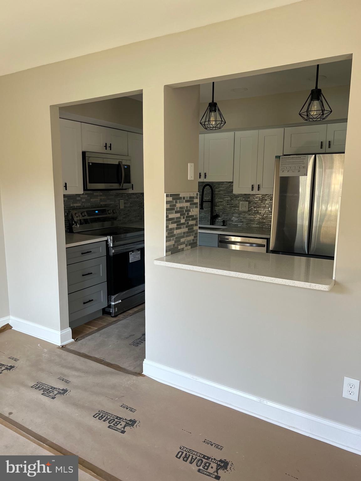 700 Ardmore Ave Ardmore Avenue, Unit 606 Ardmore, PA 19003 - Photo 18 of 32 a kitchen with stainless steel appliances granite countertop a refrigerator and a sink