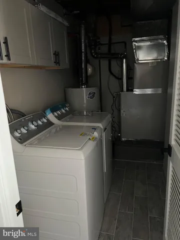 a kitchen with stainless steel appliances white cabinets and a refrigerator