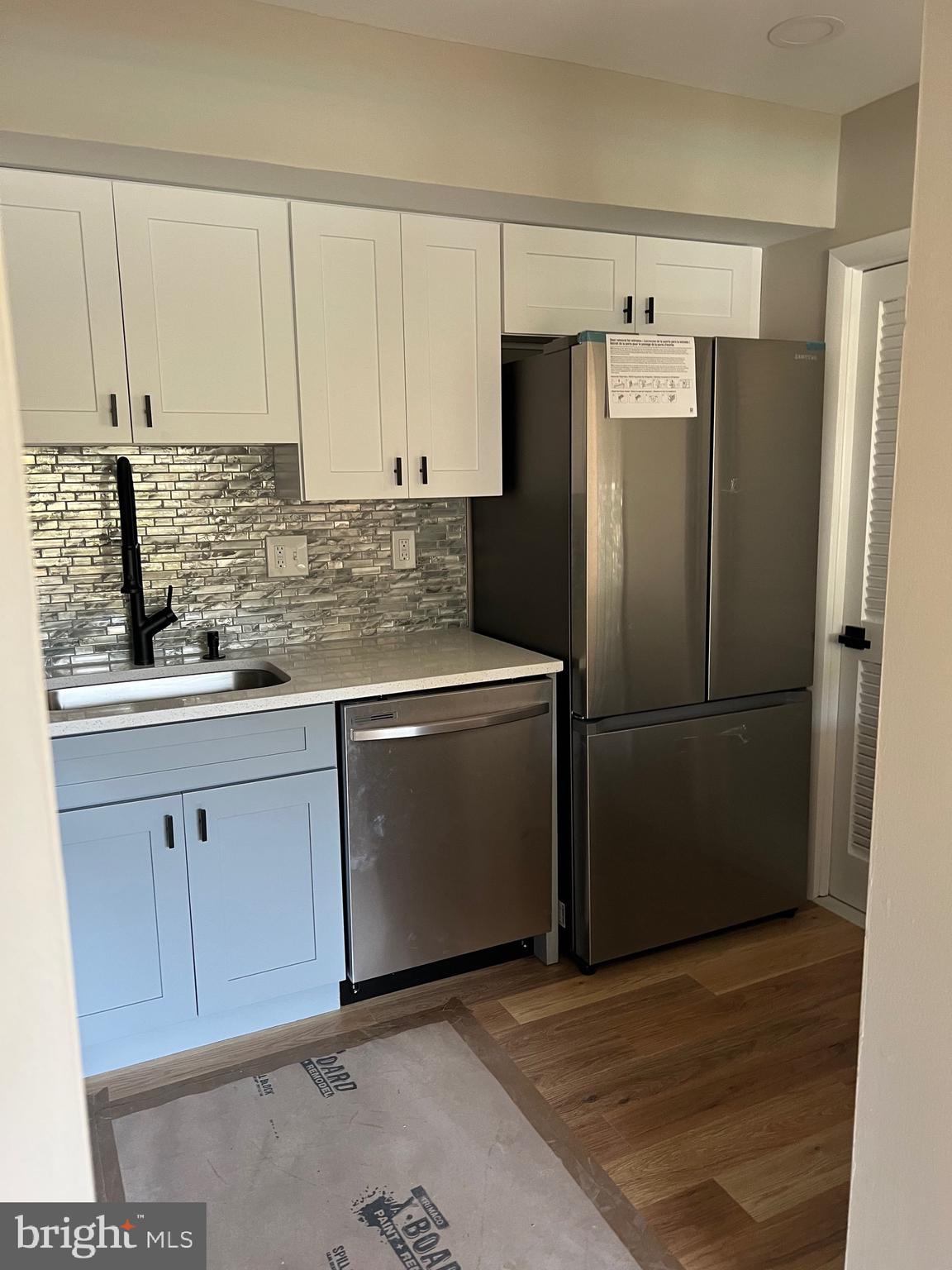 700 Ardmore Ave Ardmore Avenue, Unit 606 Ardmore, PA 19003 - Photo 21 of 32 a kitchen with stainless steel appliances white cabinets and a refrigerator