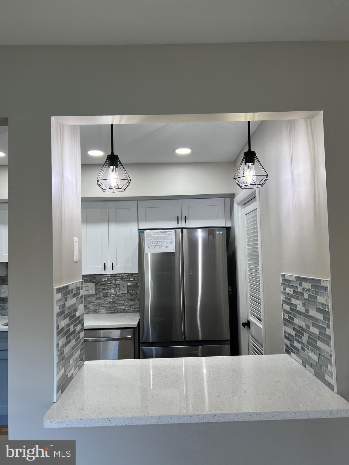 700 Ardmore Ave Ardmore Avenue, Unit 606 Ardmore, PA 19003 - Photo 23 of 32 a kitchen with stainless steel appliances a refrigerator and microwave