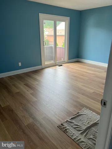 an empty room with wooden floor