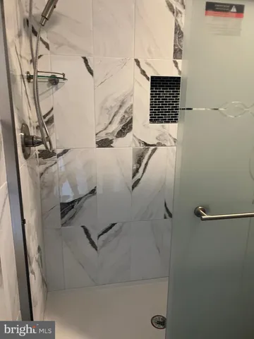 a bathroom with a granite countertop toilet sink and tub