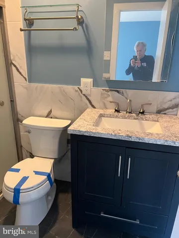 a bathroom with a sink a toilet and a mirror