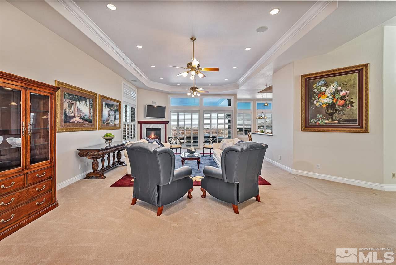 12965 Silver Wolf Road Reno, NV 89511 - Photo 8 of 40 a living room with furniture and a chandelier