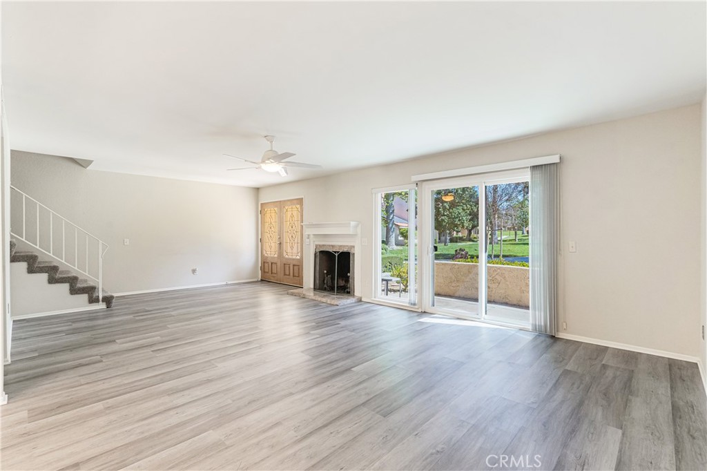 7088 Seville Way Riverside, CA 92506 - Photo 12 of 75 a view of a livingroom with wooden floor and fireplace