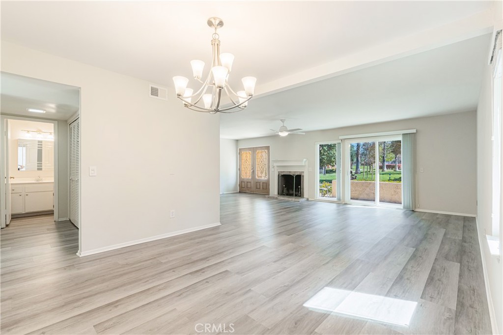 7088 Seville Way Riverside, CA 92506 - Photo 13 of 75 a view of a livingroom with wooden floor and a ceiling fan