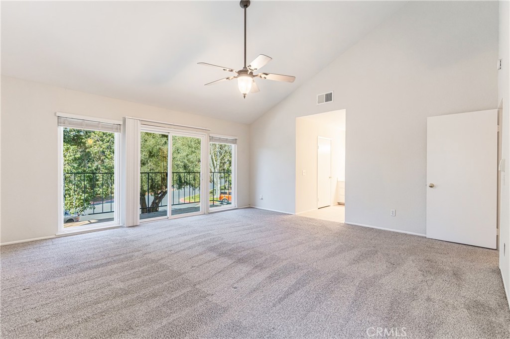 7088 Seville Way Riverside, CA 92506 - Photo 32 of 75 a view of an empty room with windows and chandelier