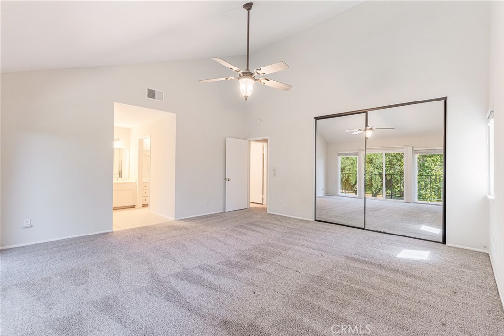 7088 Seville Way Riverside, CA 92506 - Photo 33 of 75 a view of an empty room with a window and a ceiling fan