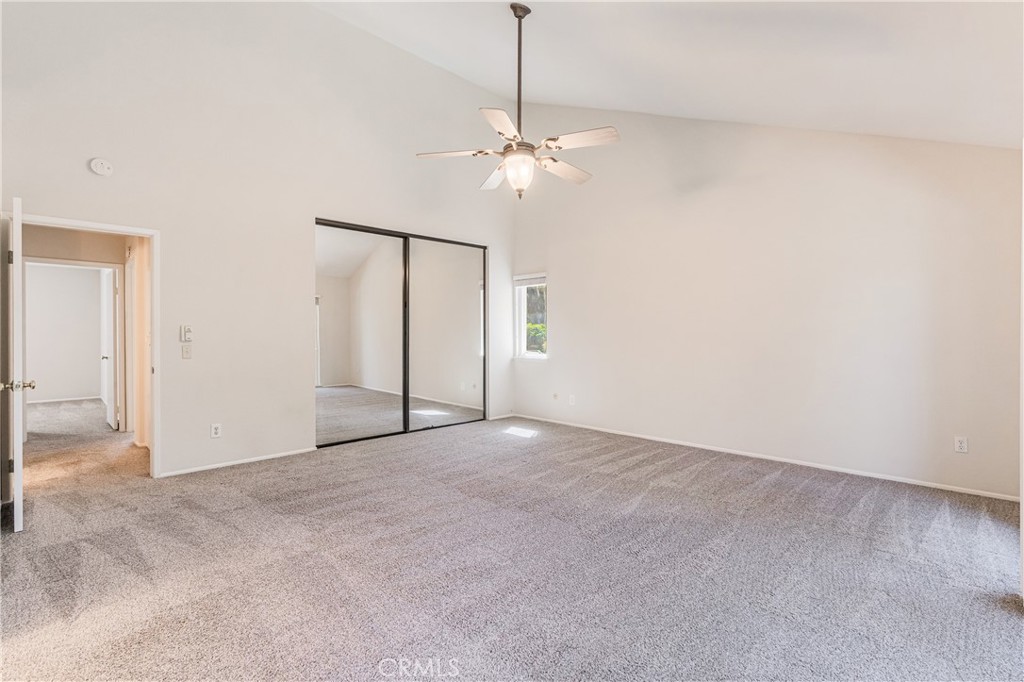 7088 Seville Way Riverside, CA 92506 - Photo 34 of 75 an empty room with closet and a chandelier fan