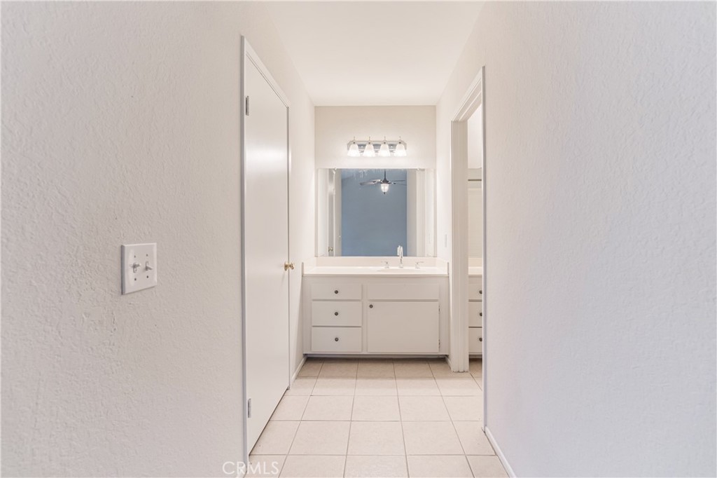 7088 Seville Way Riverside, CA 92506 - Photo 35 of 75 a view of a hallway with closet and mirror