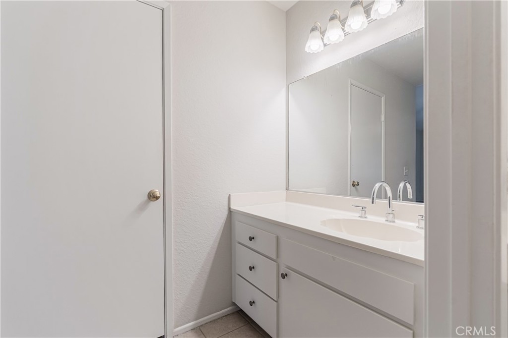 7088 Seville Way Riverside, CA 92506 - Photo 36 of 75 a bathroom with a double vanity sink and a mirror