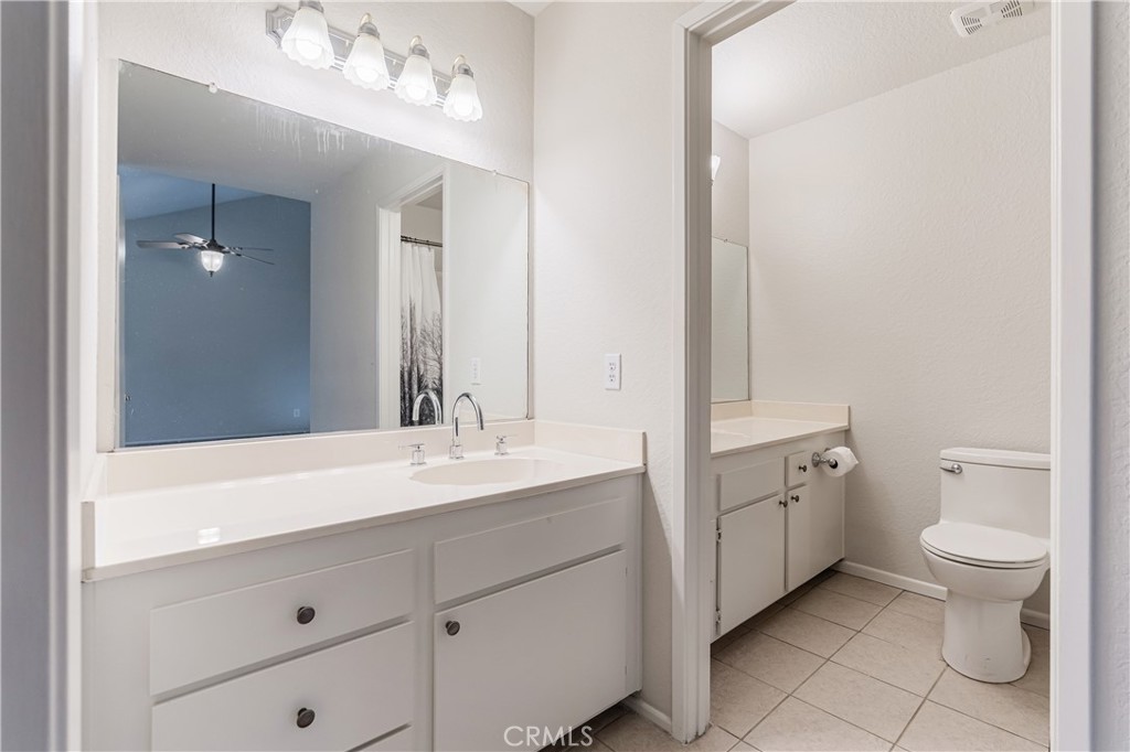 7088 Seville Way Riverside, CA 92506 - Photo 37 of 75 a spacious bathroom with a double vanity sink toilet and a mirror