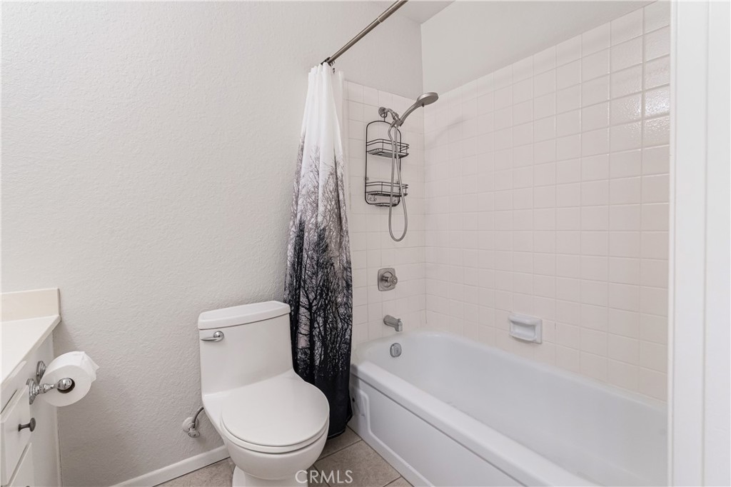 7088 Seville Way Riverside, CA 92506 - Photo 40 of 75 a white toilet sitting next to a bath tub