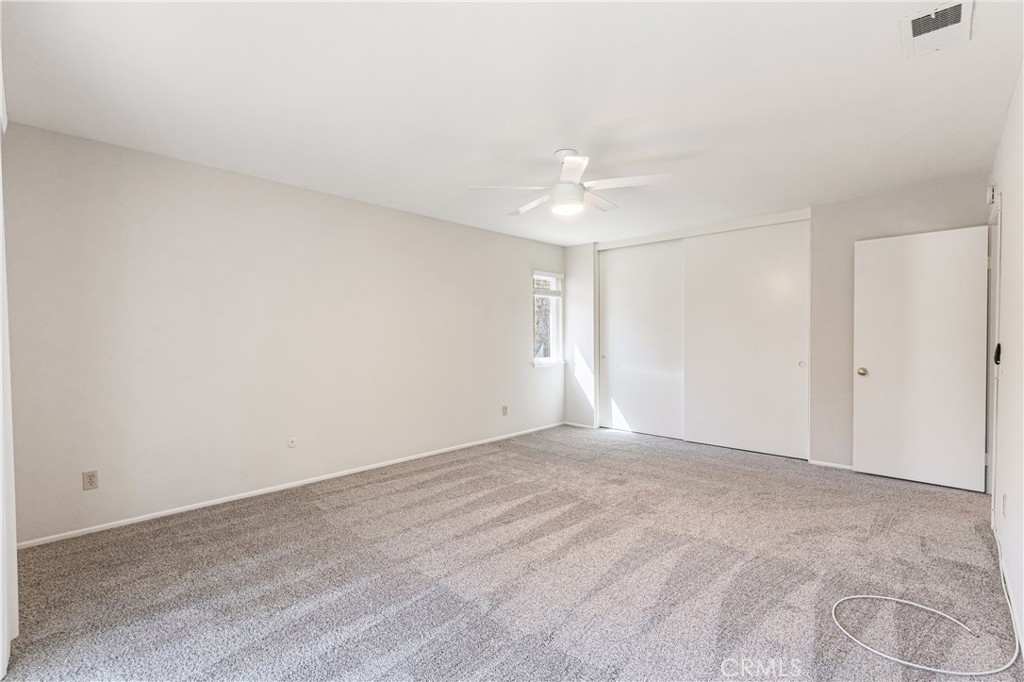 7088 Seville Way Riverside, CA 92506 - Photo 43 of 75 a view of an empty room with window and wooden floor