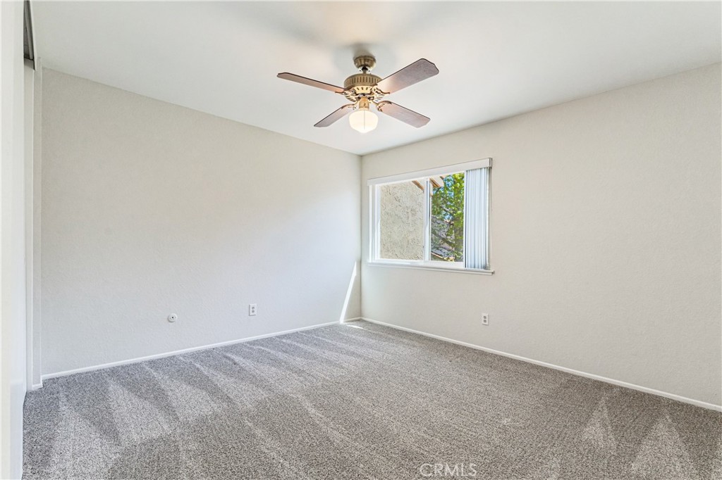 7088 Seville Way Riverside, CA 92506 - Photo 46 of 75 an empty room with a window and a fan