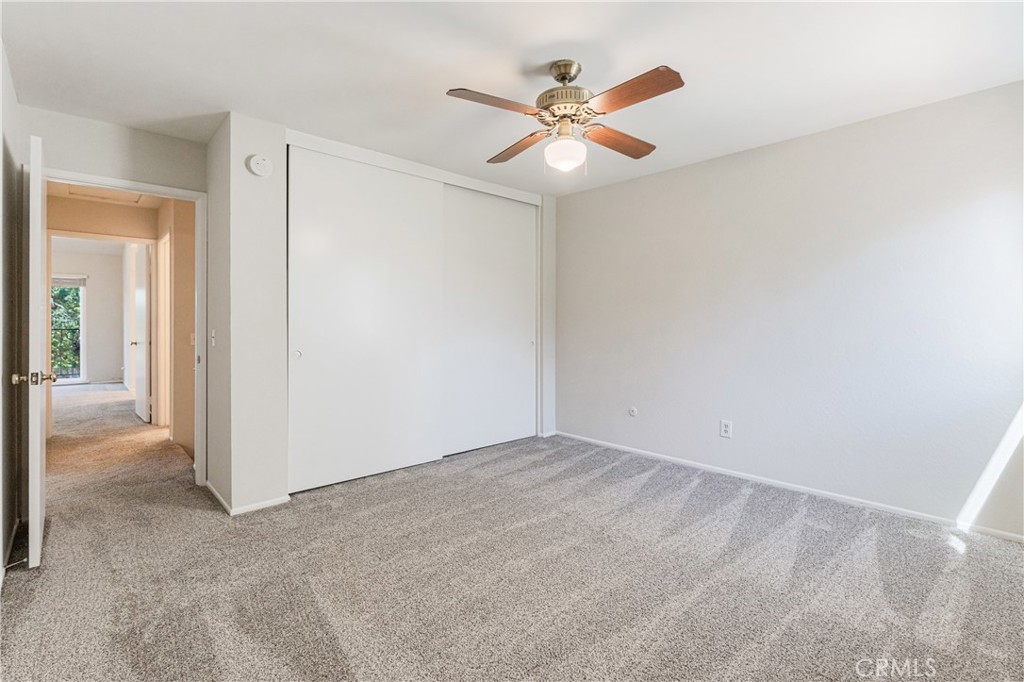 7088 Seville Way Riverside, CA 92506 - Photo 49 of 75 an empty room with closet and a chandelier fan