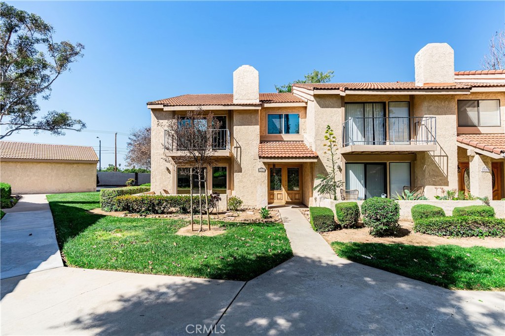 7088 Seville Way Riverside, CA 92506 - Photo 6 of 75 a front view of a house with garden