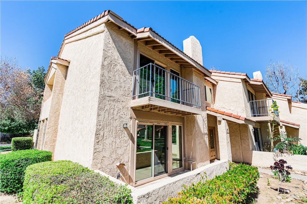 7088 Seville Way Riverside, CA 92506 - Photo 65 of 75 a view of a house with a large windows and flower plants