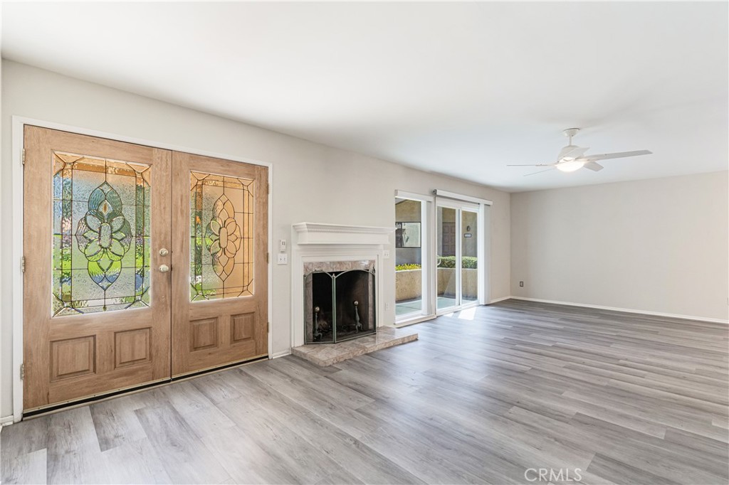 7088 Seville Way Riverside, CA 92506 - Photo 9 of 75 a view of an empty room with wooden floor and a window