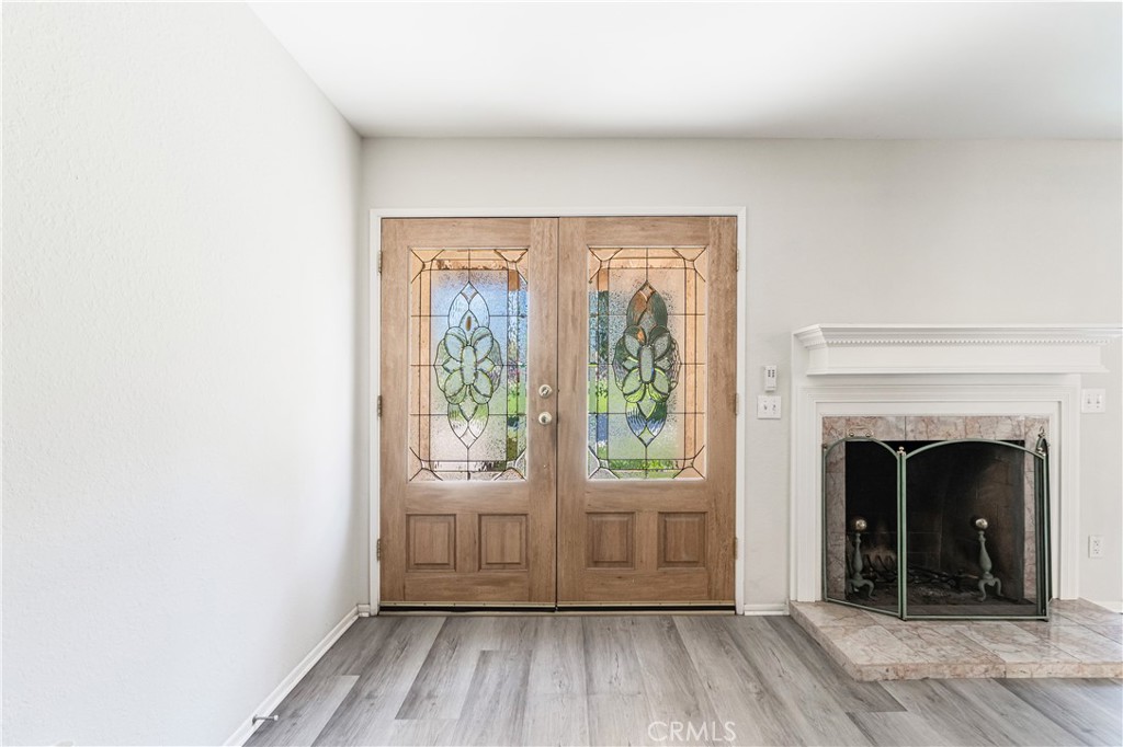 7088 Seville Way Riverside, CA 92506 - Photo 10 of 75 a view of an empty room with wooden floor and a window